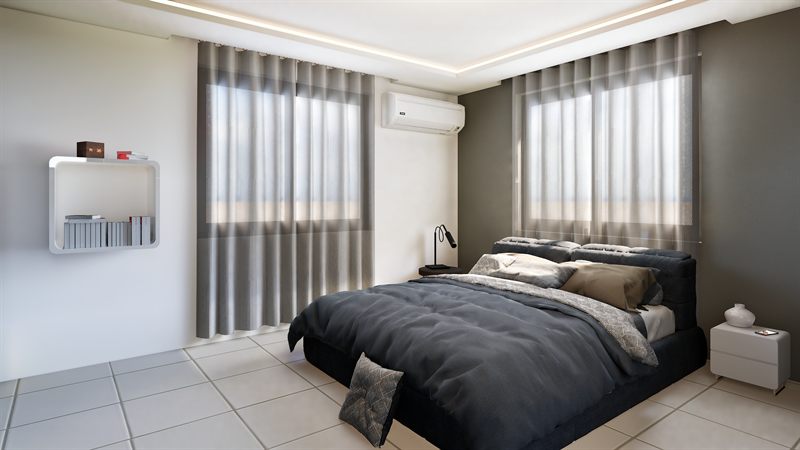 The bedroom at Project Maxpro: the bed against a dark accent wall, full-height curtains across two windows with a split air conditioner centred between them, and a reading lamp on the bedside table.