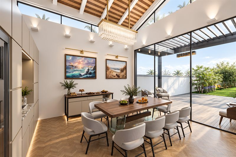Inside the dining pavilion: a long timber table under a vaulted ceiling of exposed rafters, with a fully glazed wall opening to the deck and garden.