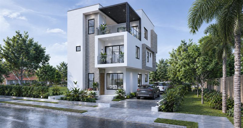 The house from the street in daylight: three storeys in white render, grey stone cladding beside the timber front door, framed balconies on the two upper floors and a dark slatted pergola over the top-floor balcony, with two cars on the drive.