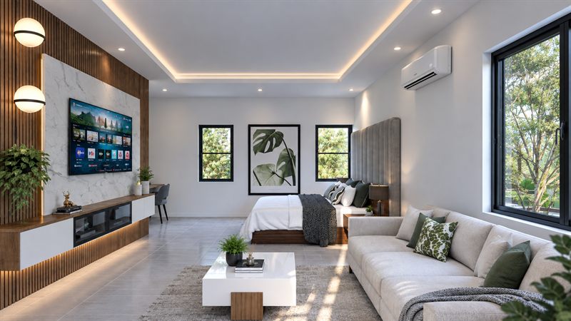The master bedroom: the bed against a tall upholstered headboard at the far end, a sofa and a white coffee table facing a slatted timber wall with a television on a marble panel, a desk beyond it, and a wide window on the right.